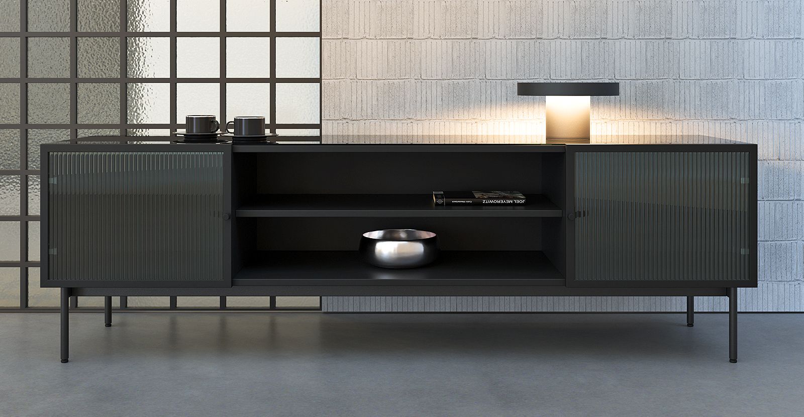 Стильна низька тумба Leon з темного матеріалу з рифленими скляними дверцятами в сучасному інтер’єрі, прикрашена лампою та декоративними предметами